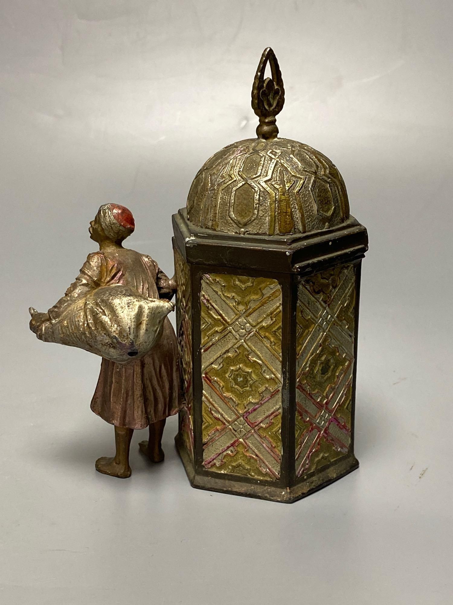 A Bergman style cold painted metal hexagonal casket, with hinged cover, Itinerant labourer alongside, 15cm